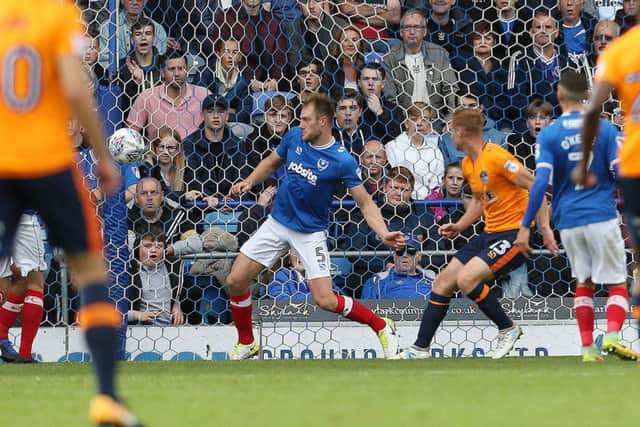 Eoin Doyle scores the opener for Oldham against Pompey Picture: Joe Pepler