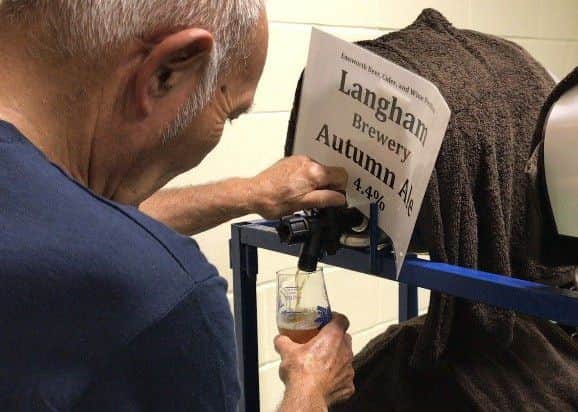 A crew member pours a pint at the Emsworth Beer and Cider Festival