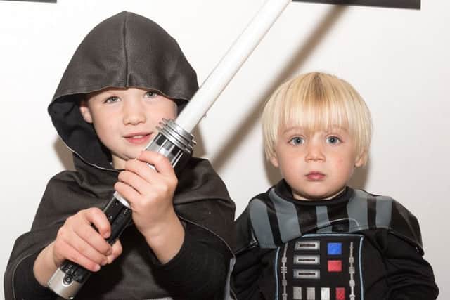 Dexter and Arlo Tipper try on some star war costumes. Picture: Keith Woodland