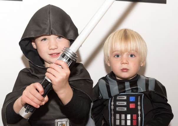 Dexter and Arlo Tipper try on some star war costumes. Picture: Keith Woodland
