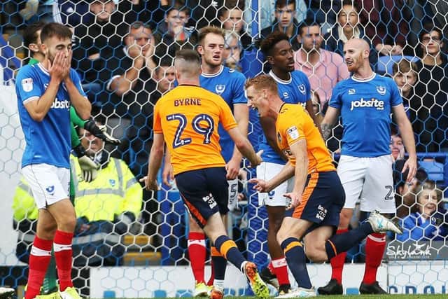 Eoin Doyle turns to celebrate after hading Oldham the lead Picture: Joe Pepler