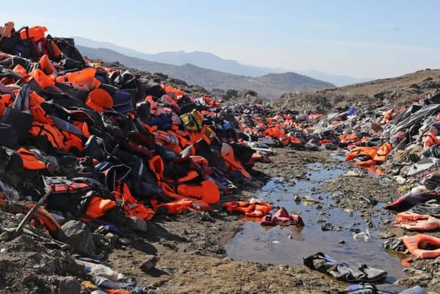 Piles of used life jackets dumped by asylum seekers after arriving at Lesbos