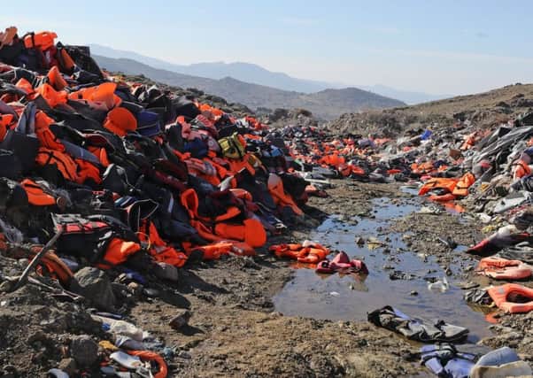 Piles of used life jackets dumped by asylum seekers after arriving at Lesbos