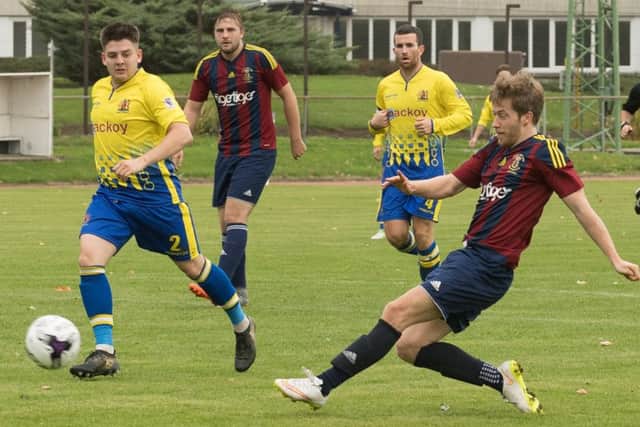 Mark Cotten scores for United Services in their 3-3 draw with Romsey. Picture: Keith Woodland