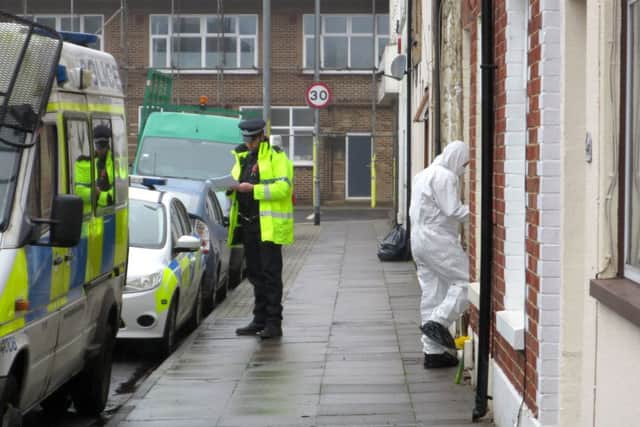 Forensics officers enter a home in Toronto Road, Buckland