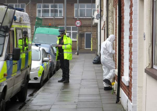 Forensics officers enter a home in Toronto Road, Buckland