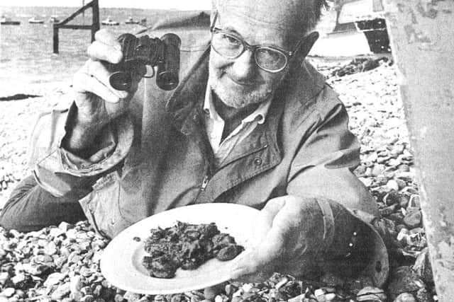 Discoverer of the Mary Rose, Alexander McKee on the lookout at the Ferrypoint, Hayling, for another wildcat, aided by binoculars and a plate of cat food
