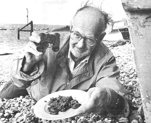 Discoverer of the Mary Rose, Alexander McKee on the lookout at the Ferrypoint, Hayling, for another wildcat, aided by binoculars and a plate of cat food