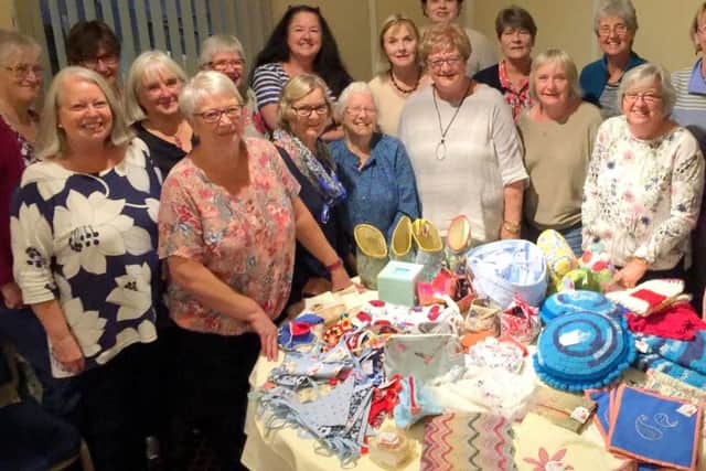 Members of Material Girls with their collection of work for the Portsmouth Cancer Trust.