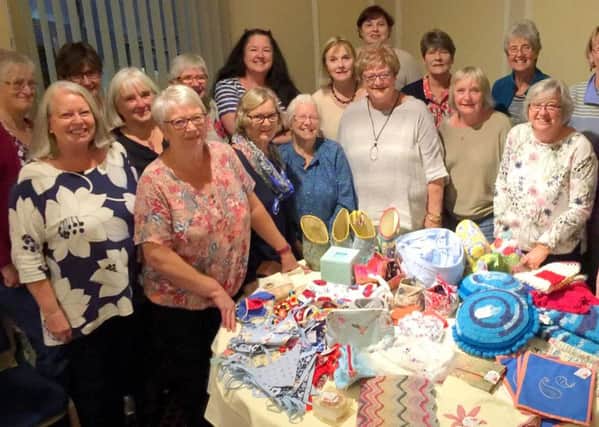 Members of Material Girls with their collection of work for the Portsmouth Cancer Trust.