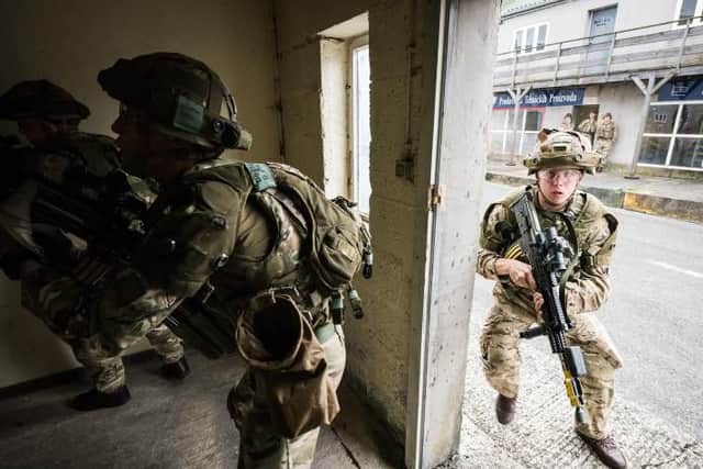 Soldiers on house clearance and contact drills within the Urban Defence Training Area of Sennelager Training Centre.