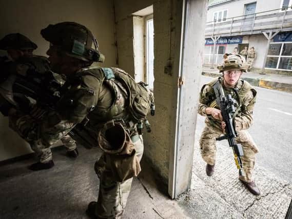 Soldiers on house clearance and contact drills within the Urban Defence Training Area of Sennelager Training Centre.