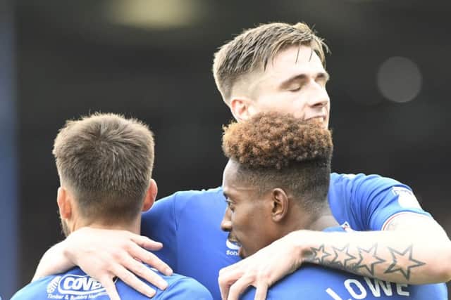 Oli Hawkins, centre, celebrates with Ben Close, left, and Jamal Lowe. Picture: Joe Pepler