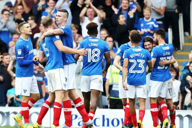 Pompey celebrate Oli Hawkins' first goal against MK Dons. Pictures: Joe Pepler