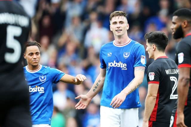 Kyle Bennett, left, congratulates Oli Hawkins after his second goal in Pompey's 2-0 win against MK Dons. Picture: Joe Pepler