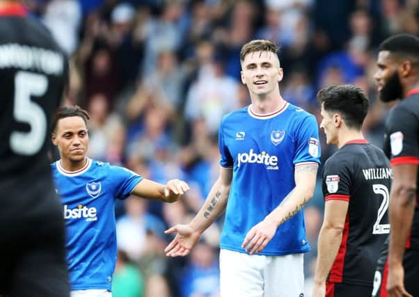 Kyle Bennett, left, congratulates Oli Hawkins after his second goal in Pompey's 2-0 win against MK Dons. Picture: Joe Pepler