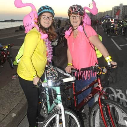 With famingos in tow, Victoria Hamment and Charlotte Cox, from Southsea, get ready to cyle (171233-01)