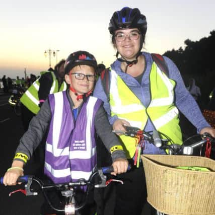 Toby Lander, eight, with his aunty Coco Johnson all geared up for the ride (171233-04)