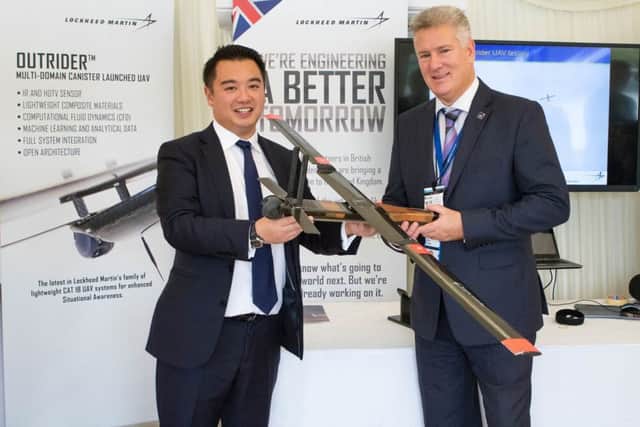 Alan Mak and Klaus Schwab examine the Outrider drone designed in Havant by Lockheed Martin