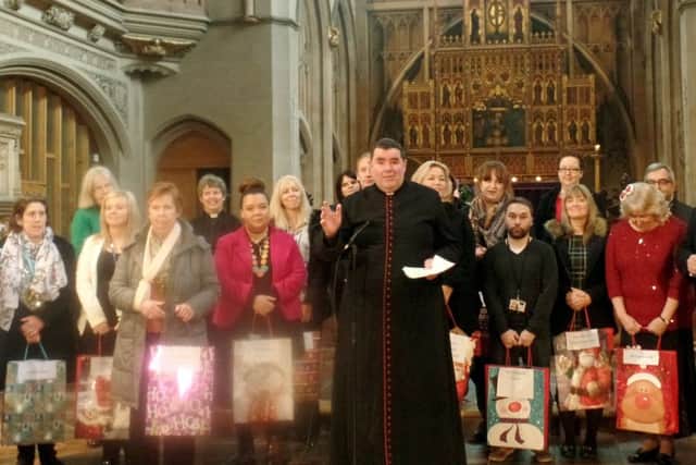 Representatives from agencies that help homeless people and vulnerable families receive cards and gift vouchers at last year's service