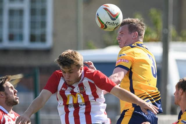Gosport Borough captain Luke King heads the ball clear. Picturet: Keith Woodland