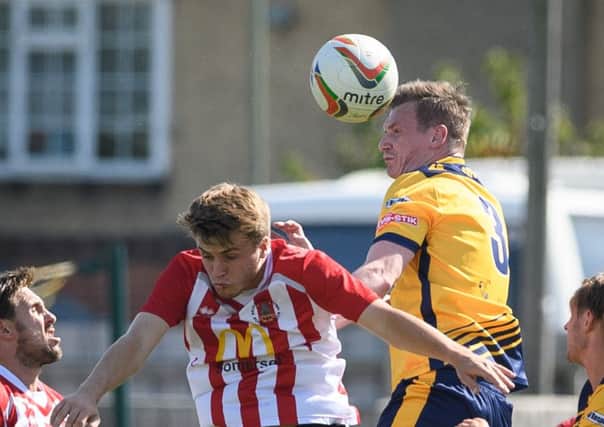 Gosport Borough captain Luke King heads the ball clear. Picturet: Keith Woodland