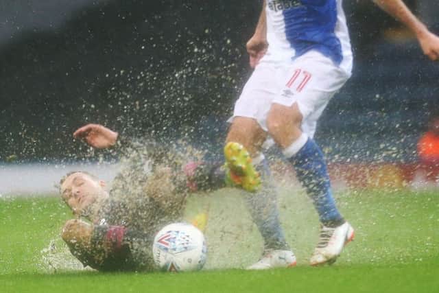 Stuart O'Keefe makes a tackle amid worsening conditions at Ewood Park. Picture: Joe Pepler