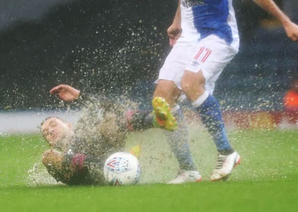Stuart O'Keefe makes a tackle amid worsening conditions at Ewood Park. Picture: Joe Pepler