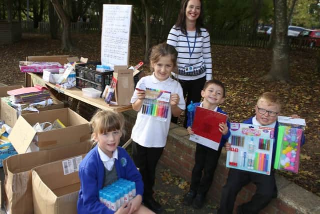 Headteacher Lucy Ford with Year 1 and Year 2 pupils with all the donations
Picture: Habibur Rahman (171465-5)