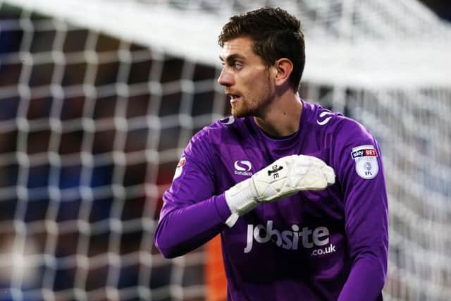 Pompey keeper Luke McGee is awaiting the results of a scan on an injured quad muscle in his left leg