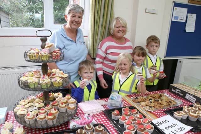 Staff and children from Dream Catchers selling cupcakes and cookies (171466-3)