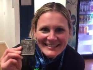 Claire with her Great South Run medal. Picture: David Hart