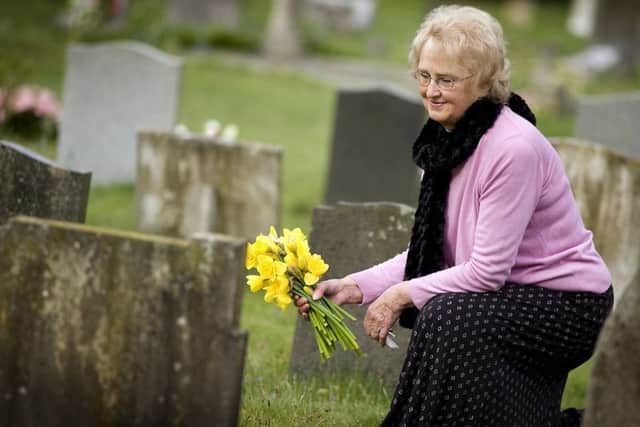 REMEMBERING Mary Close visits the grave of her husband in the churchyard at St Johns, Rowlands Castle