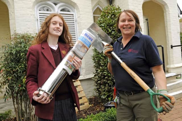 Rachel Barham with the time capsule and 'Jen' Shivjee, the Grounds Facility Team Manager at the school who was seconded to dig a deep hole for the time capsule Picture by:  Malcolm Wells