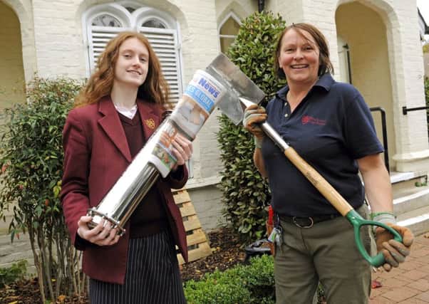 Rachel Barham with the time capsule and 'Jen' Shivjee, the Grounds Facility Team Manager at the school who was seconded to dig a deep hole for the time capsule 

Picture by:  Malcolm Wells