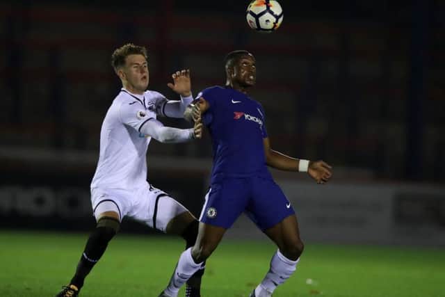 Swansea City's Joe Rodden, left, battles for possession of the ball with Chelsea's Victor Adeboyejo. Picture: PA Images