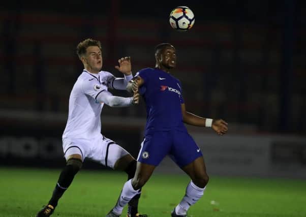Swansea City's Joe Rodden, left, battles for possession of the ball with Chelsea's Victor Adeboyejo. Picture: PA Images