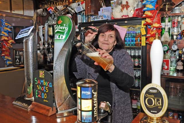 Bernice Gofton behind the bar of the Painters Arms in Lake Road