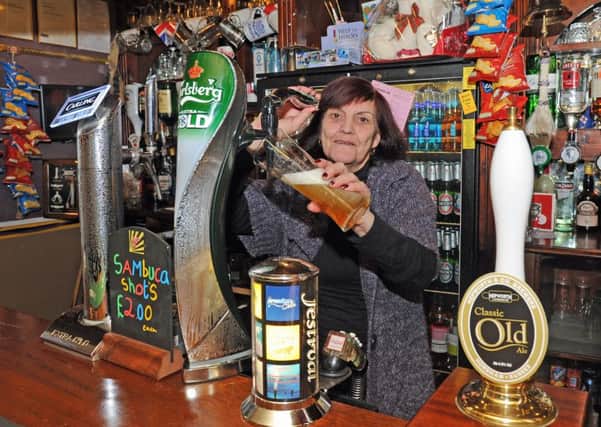 Bernice Gofton behind the bar of the Painters Arms in Lake Road