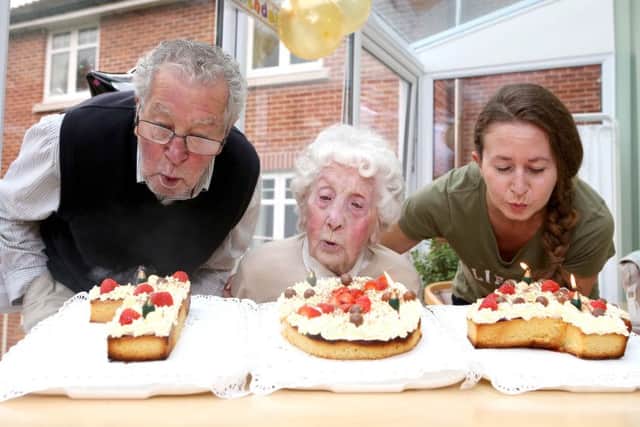 Mary Pead blows out the candles on her 104th birthday cake with her son Greg Pead and granddaughter Luisa Stallard. Picture: Habibur Rahman PPP-171017-183144001