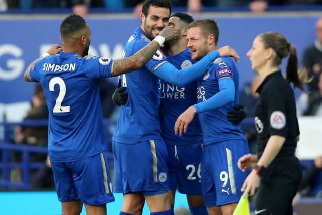 Jamie Vardy, right, is mobbed by his Leicester team-mates following his goal against Everton on Sunday