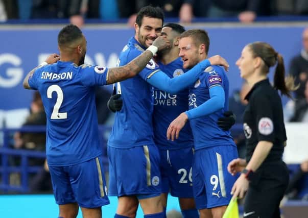 Jamie Vardy, right, is mobbed by his Leicester team-mates following his goal against Everton on Sunday