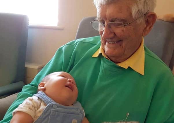 Gordon Faucon with baby Elijah Snuggs at Lockswood Day Centre in Locks Heath      Picture: Mandy Rowlands