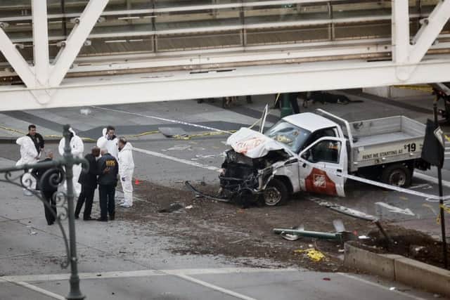 Investigators next to the killer's rental truck