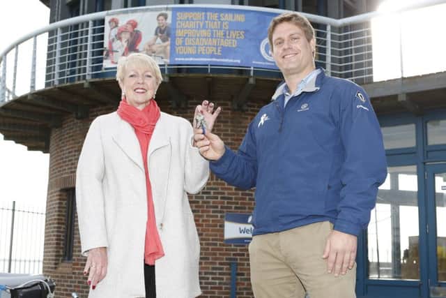 Cllr Linda Symes hands over the watersports centre keys to Andrew Simpson Sailing Foundation CEO Richard Percy
