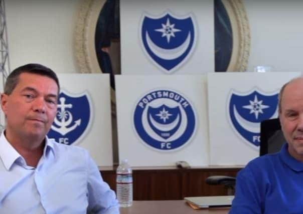 Pompey chief executive Mark Catlin, left, with club owner Michael Eisner with five Pompey crest early designs in the background
