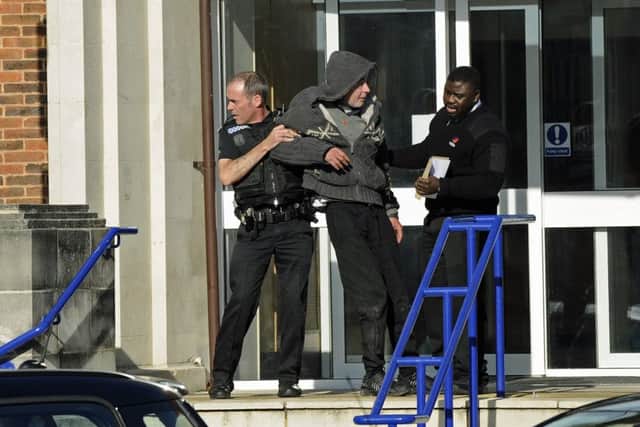 Thomas Barrett is removed in a drunken state from Portsmouth Magistrates' Court steps this morning