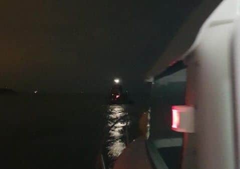The GAFIRS boat, with the fishing vessel being towed in the foreground. Picture: GAFIRS