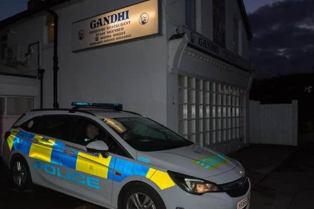 A police car outside Gandhi Tandoori in Hollow Lane on Saturday night. Picture: Vernon Nash