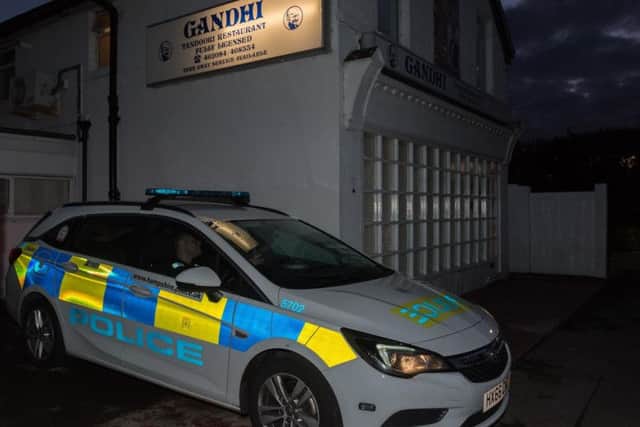 A police car parked outside Gandhi, Hollow Lane, last night. Picture: Vernon Nash